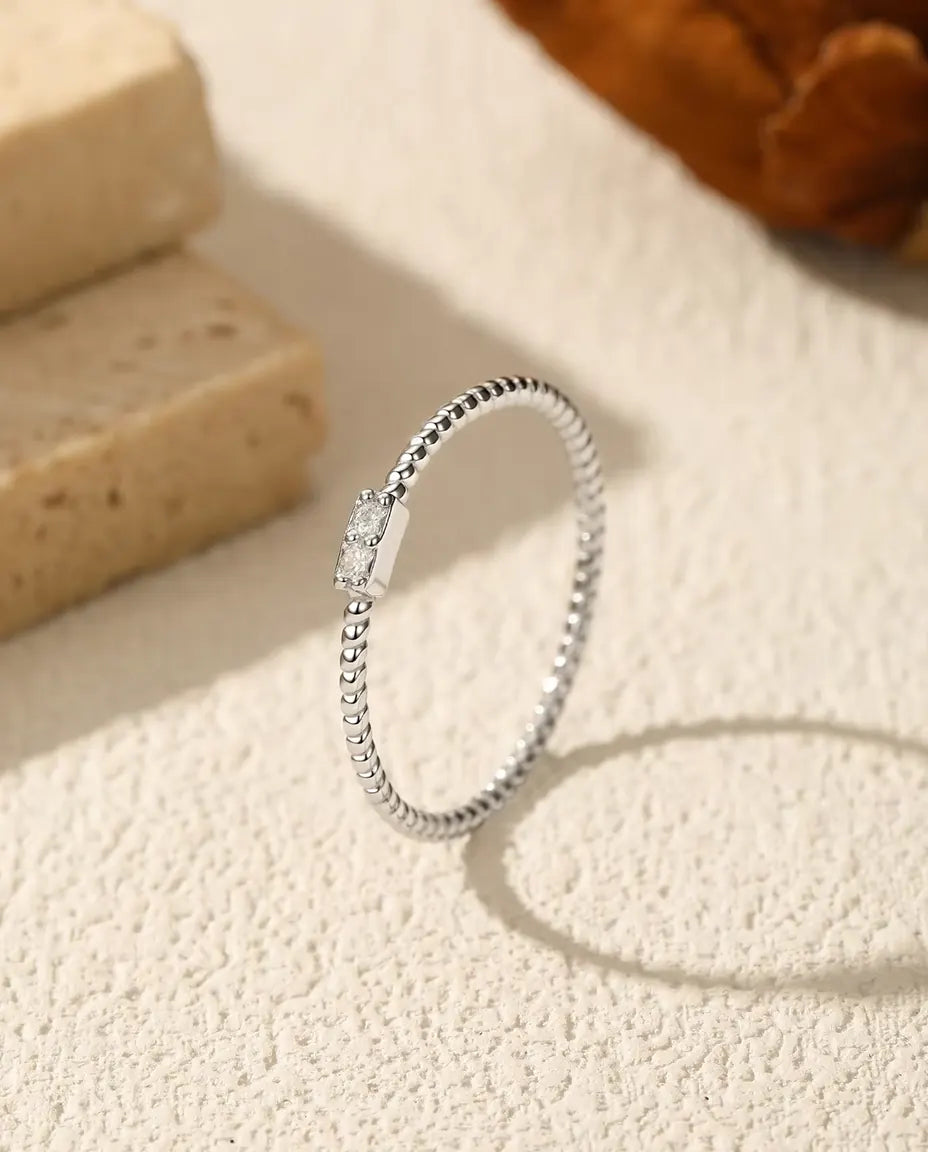 Gedraaide ring met moissaniet - twee stenen van 1,5 mm kleur D / VVS1 in een staafje van 4 mm, 925 zilver, maten 5-9