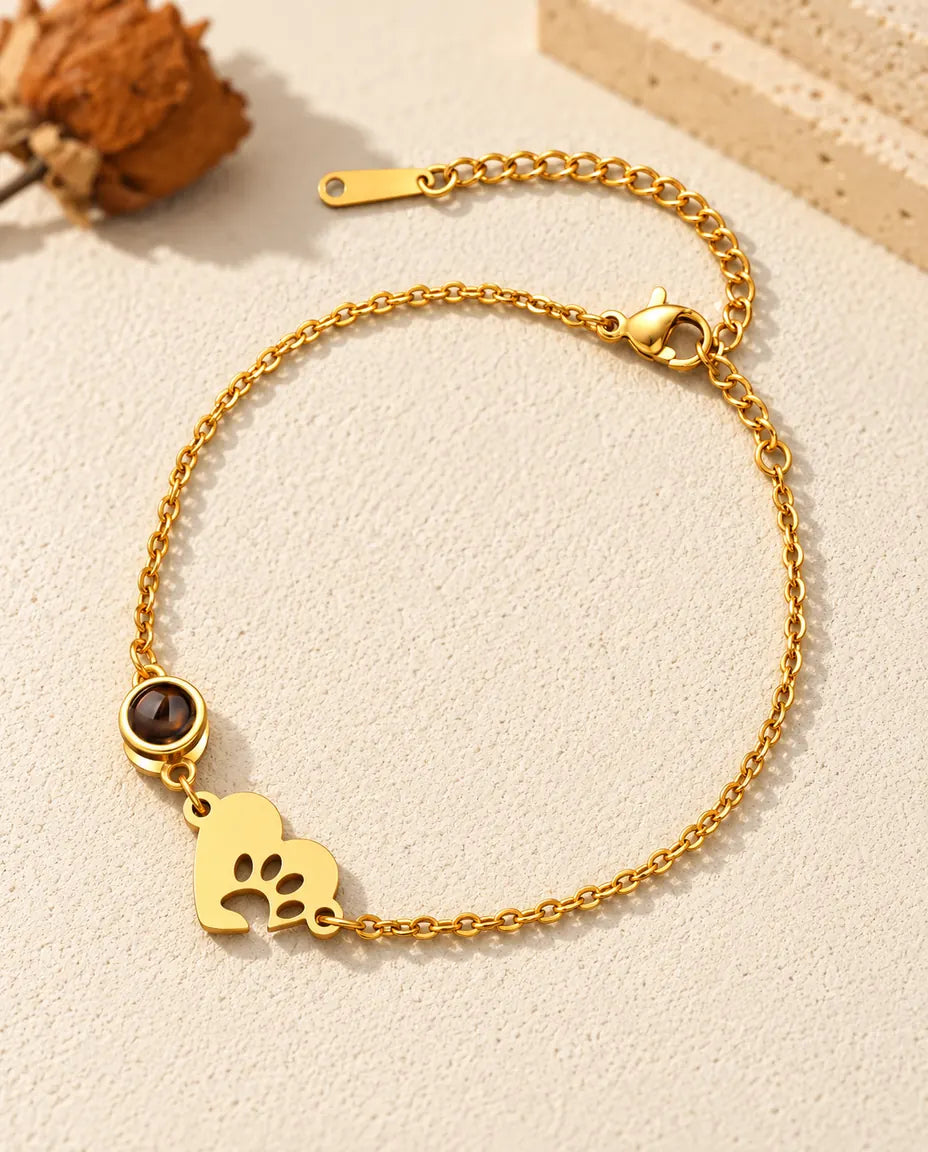 Goudkleurige armband voor huisdierliefhebbers met een hartje met pootafdruk en een verlengketting