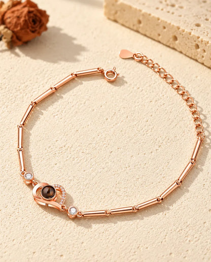 Roségoudkleurige armband met foto erin en open hartje, met staafjesketting en verlengketting