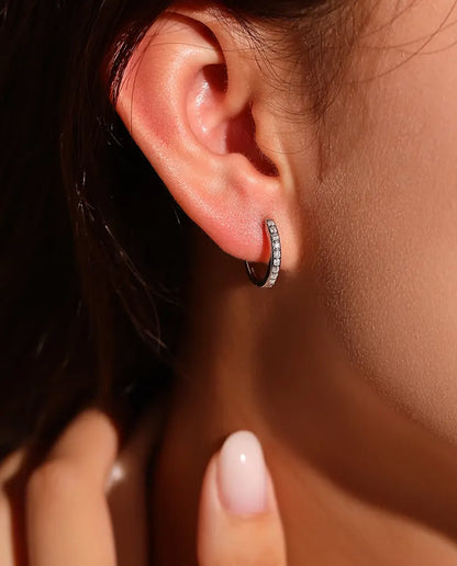 Moissanite Creolen in 925 Sterling Zilver - gedragen in het oor van een model, hand bij het gezicht